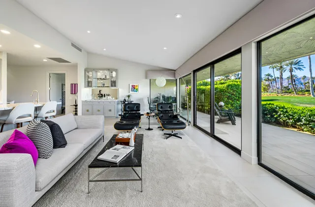 a kitchen with granite countertop kitchen island stainless steel appliances sink microwave and cabinets