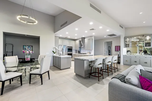 a kitchen with stainless steel appliances granite countertop a refrigerator sink and cabinets