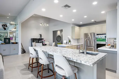 a kitchen with a sink and white cabinets