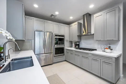 a kitchen with sink and view of living room