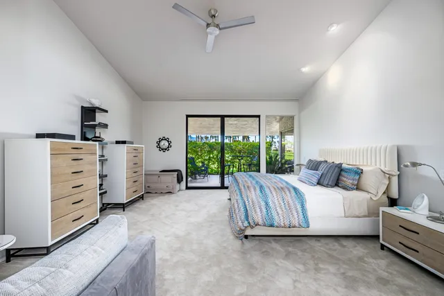 a bedroom with a bed couch and window