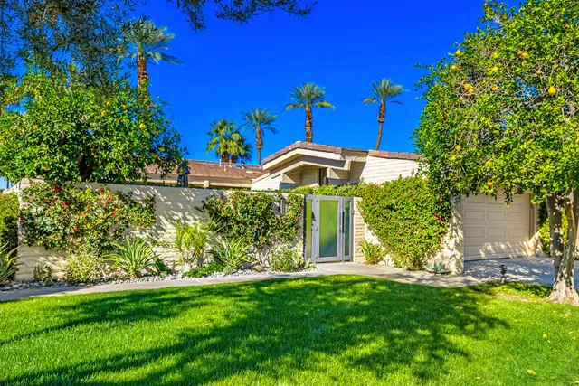 a view of a house with backyard sitting area and garden