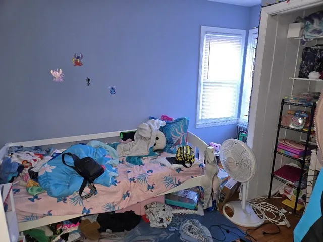 a bedroom with bed and window