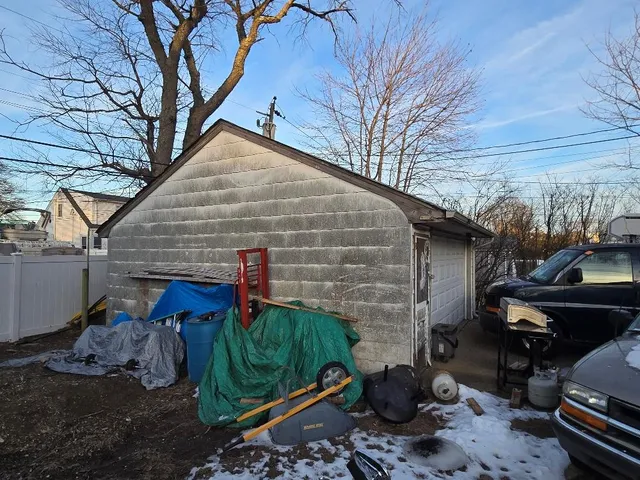 a view of a backyard with plants and a barbeque