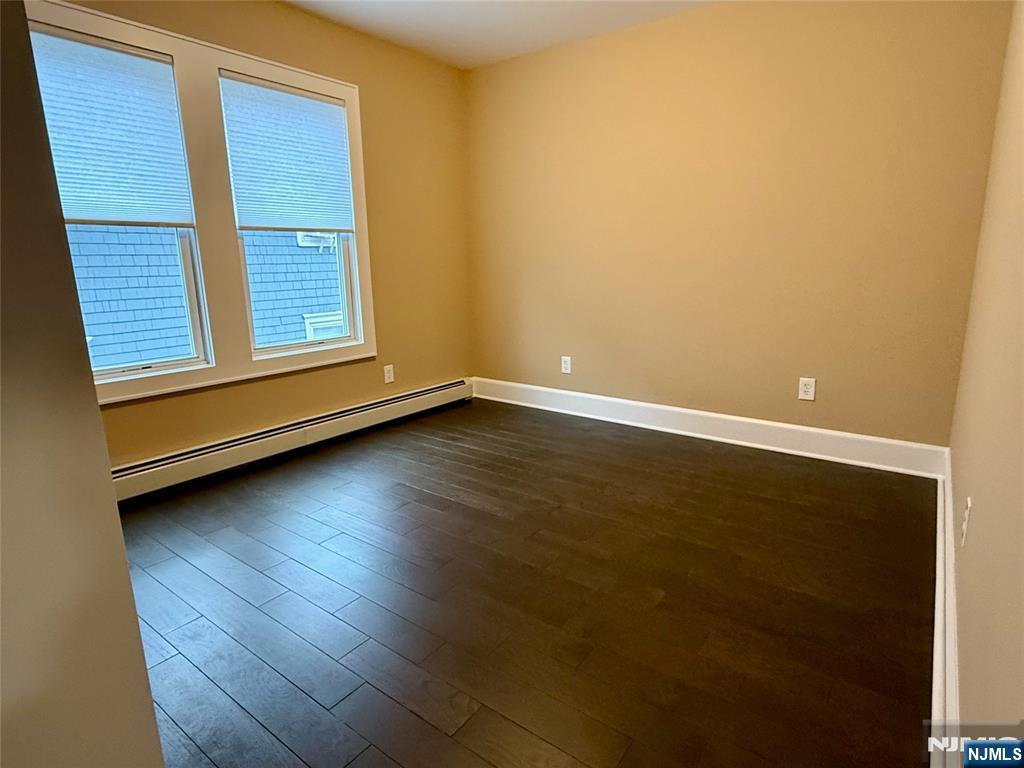 59 Laurel Avenue, Unit RIGHT SIDE Kearny, NJ 07032 - Photo 9 of 16 an empty room with wooden floor and windows