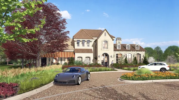 a front view of a house with a garden and yard