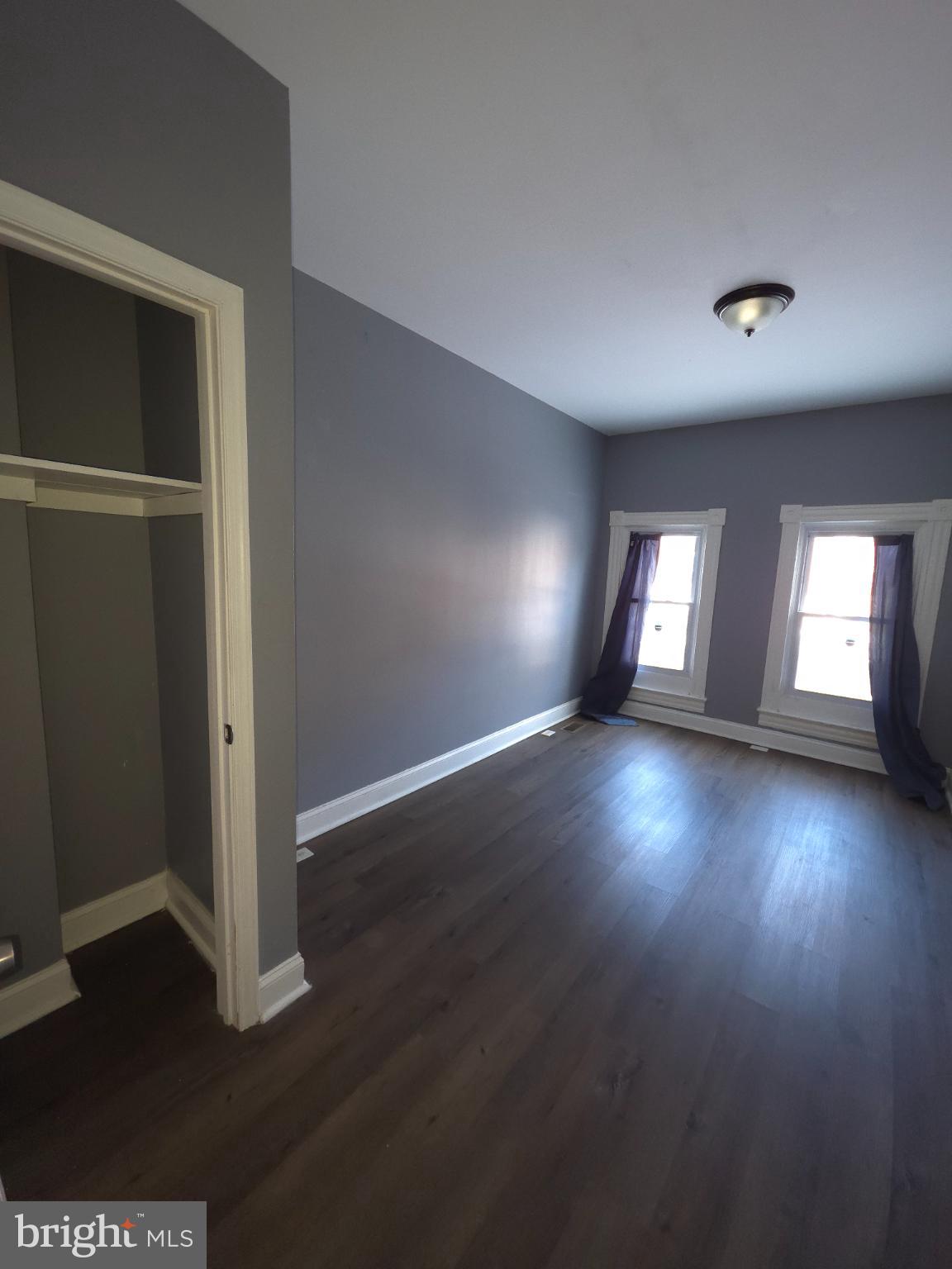 2617 East Preston Street Baltimore, MD 21213 - Photo 13 of 30 an empty room with wooden floor and windows