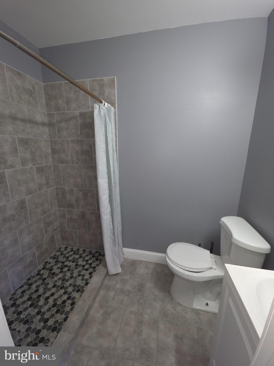 2617 East Preston Street Baltimore, MD 21213 - Photo 18 of 30 a bathroom with a toilet and a shower