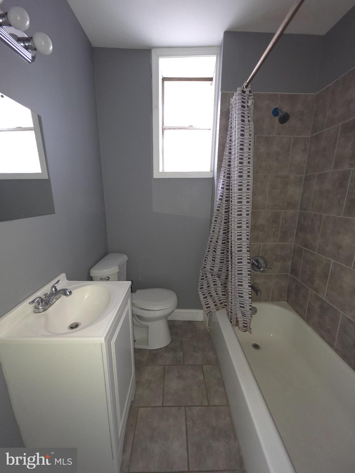 2617 East Preston Street Baltimore, MD 21213 - Photo 21 of 30 a bath room with a toilet and a bath tub
