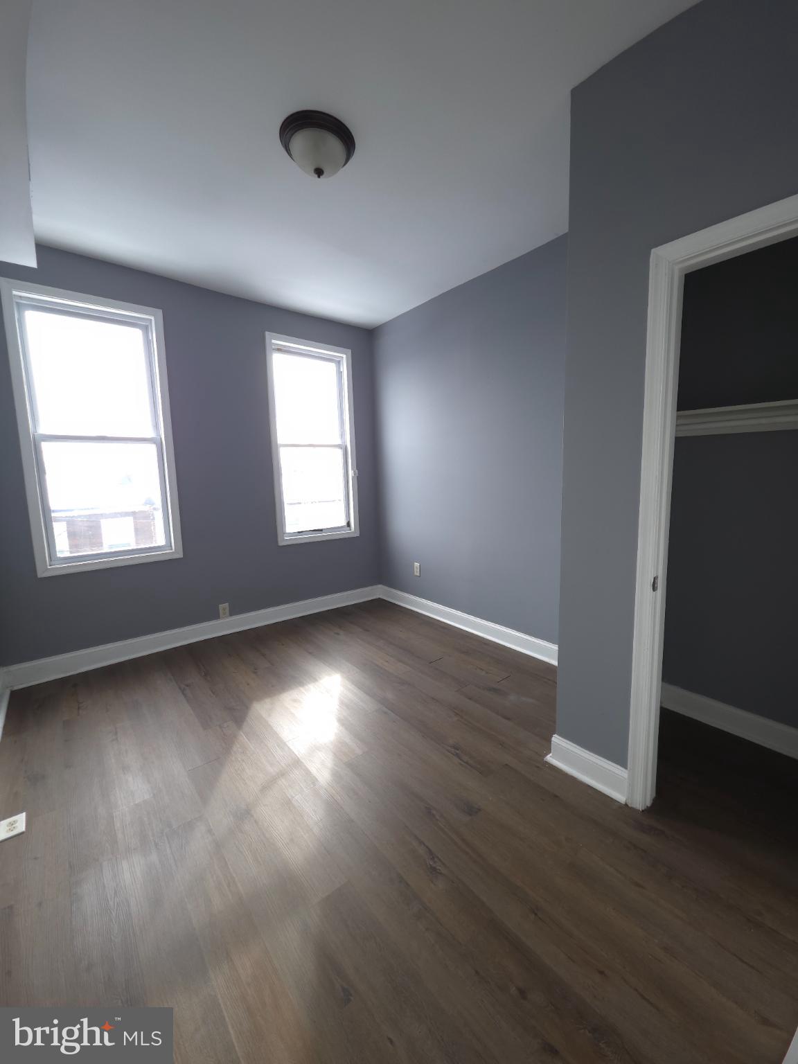 2617 East Preston Street Baltimore, MD 21213 - Photo 23 of 30 an empty room with wooden floor and windows