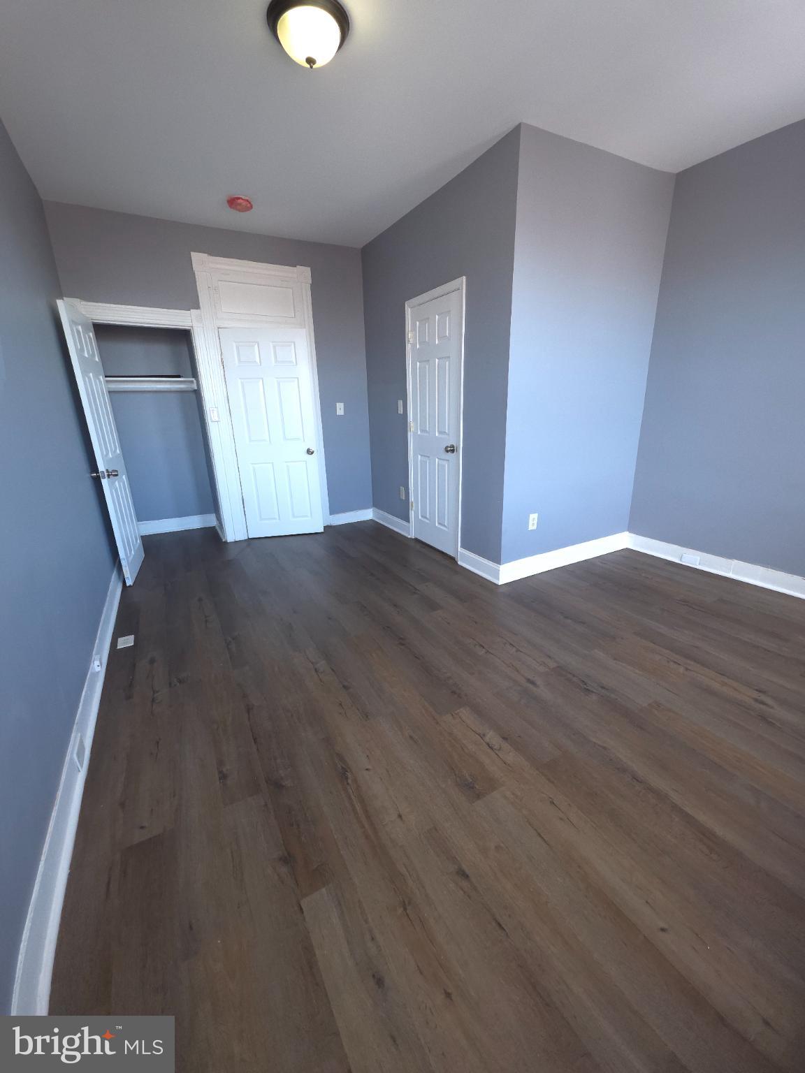2617 East Preston Street Baltimore, MD 21213 - Photo 25 of 30 a view of an empty room with wooden floor and window