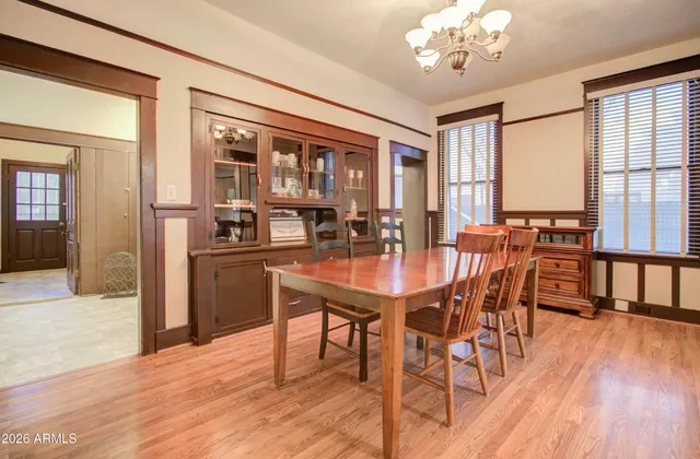 a dining room with furniture and wooden floor