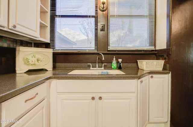 a kitchen with stainless steel appliances granite countertop a sink and a refrigerator