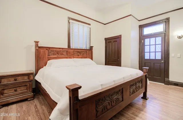 a bed sitting in a bedroom next to a cabinet