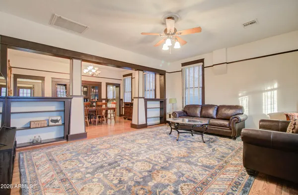 a living room with furniture a flat screen tv and a large window