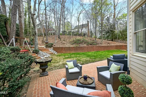 a view of a backyard with sitting area and furniture