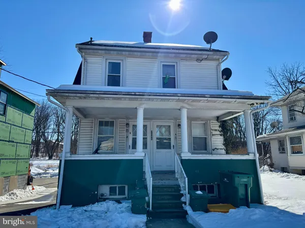 a view of a house with a porch and furniture