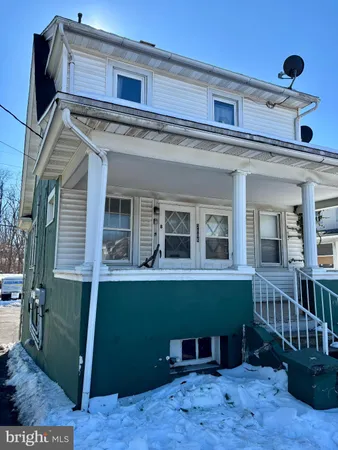 a view of front door of house with deck