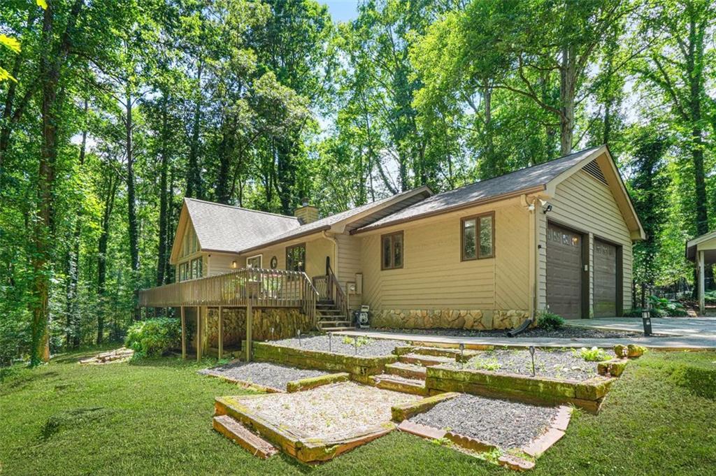 a view of a house with pool and a yard