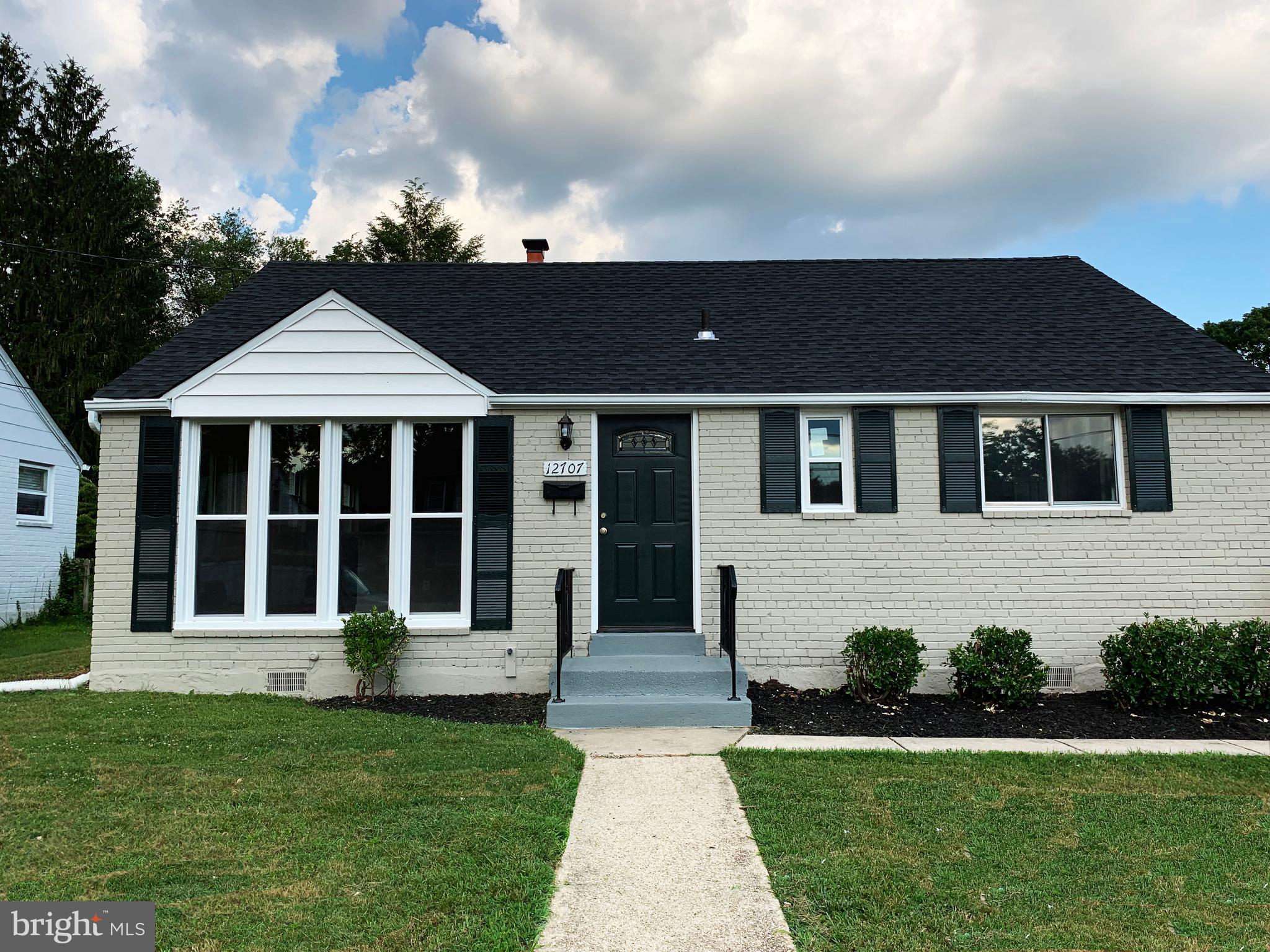 12707 Gould Road Silver Spring, MD 20906 - Photo 1 of 23 a front view of a house with a garden