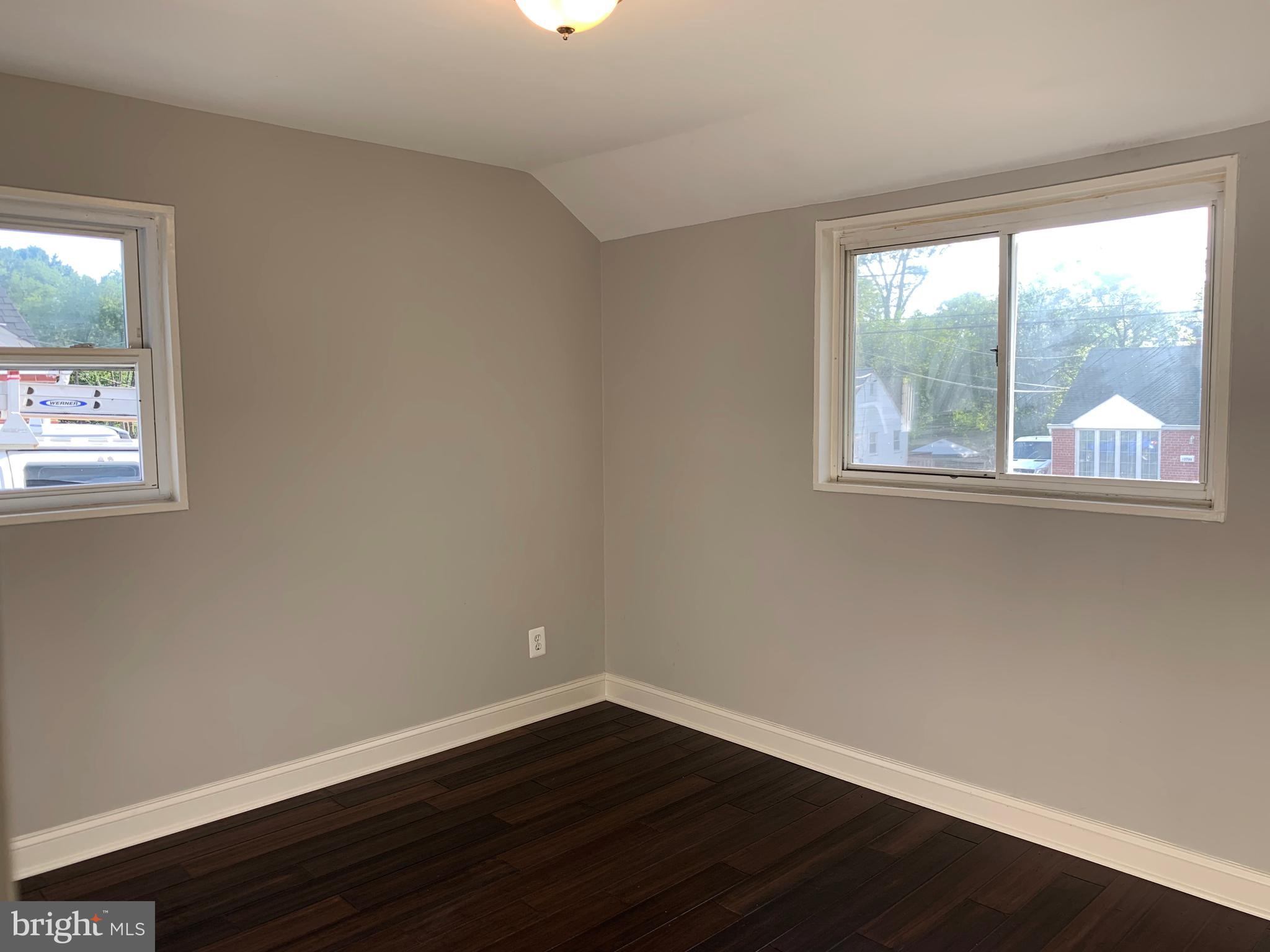 12707 Gould Road Silver Spring, MD 20906 - Photo 18 of 23 an empty room with wooden floor and windows