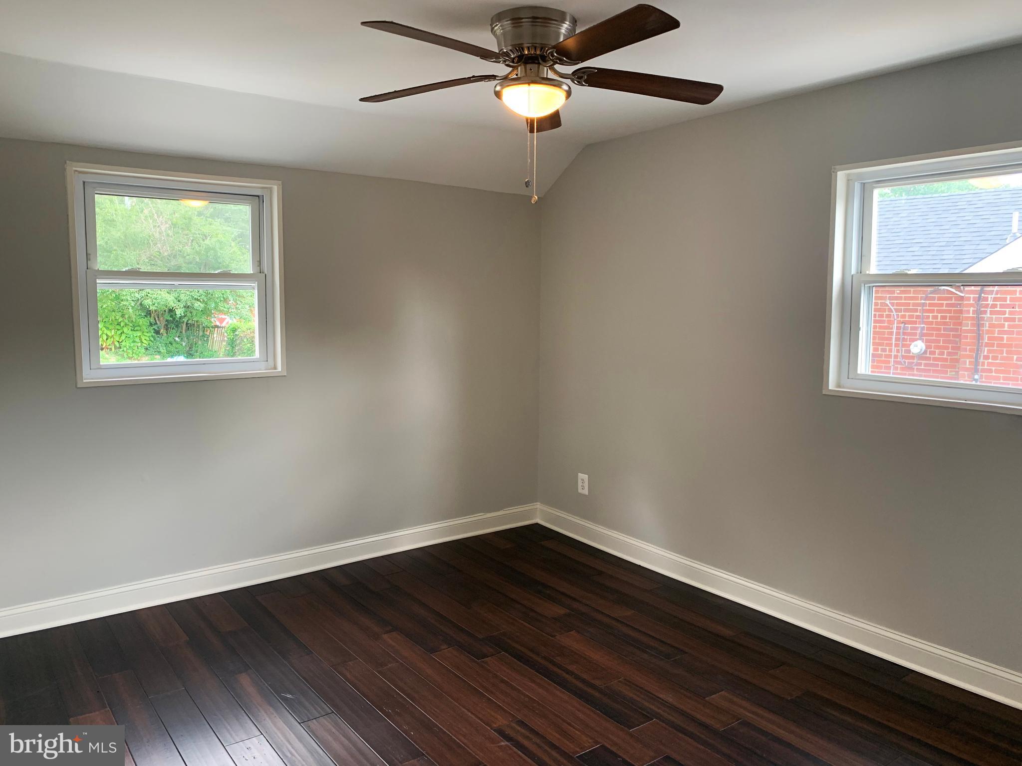 12707 Gould Road Silver Spring, MD 20906 - Photo 20 of 23 a view of an empty room with wooden floor and a window