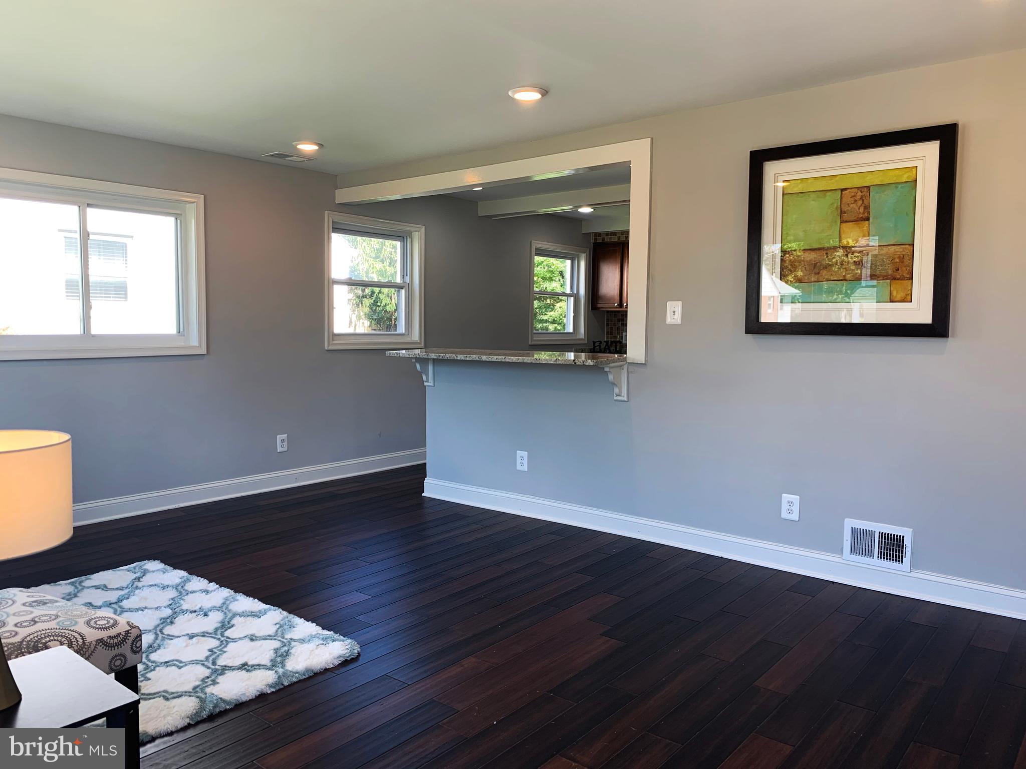 12707 Gould Road Silver Spring, MD 20906 - Photo 7 of 23 a view of an empty room with wooden floor and a window