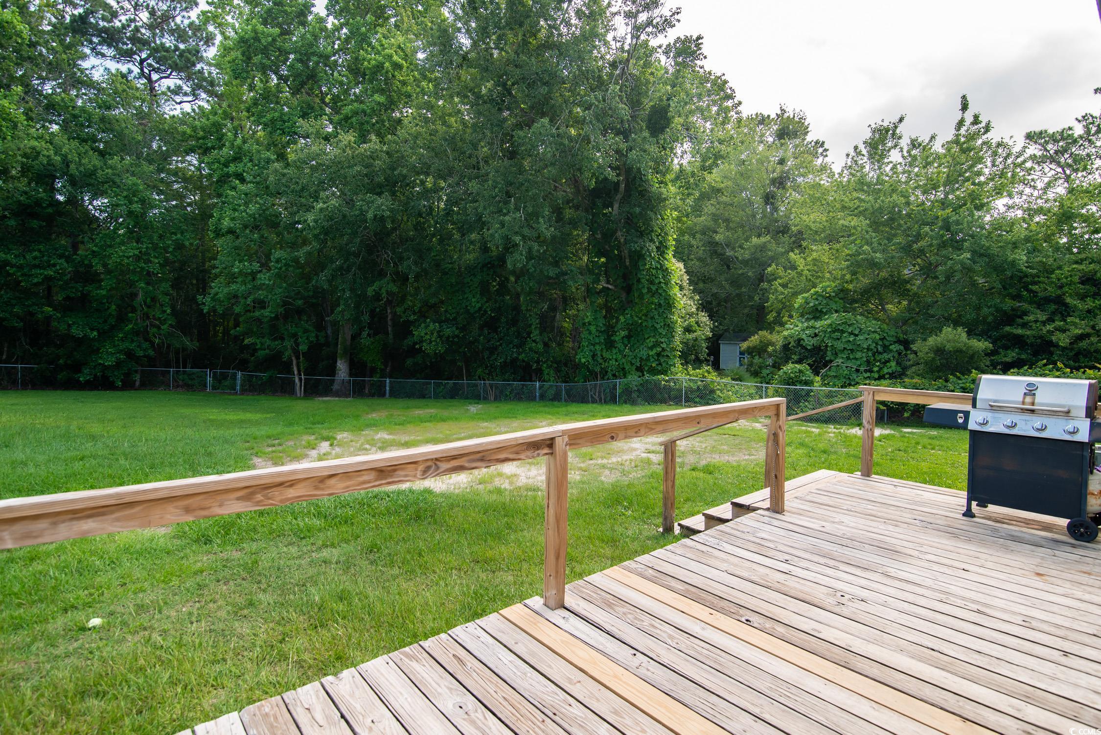 66 Johnstone Lane Georgetown, SC 29440 - Photo 35 of 40 Wooden deck featuring area for grilling and a fenced backyard