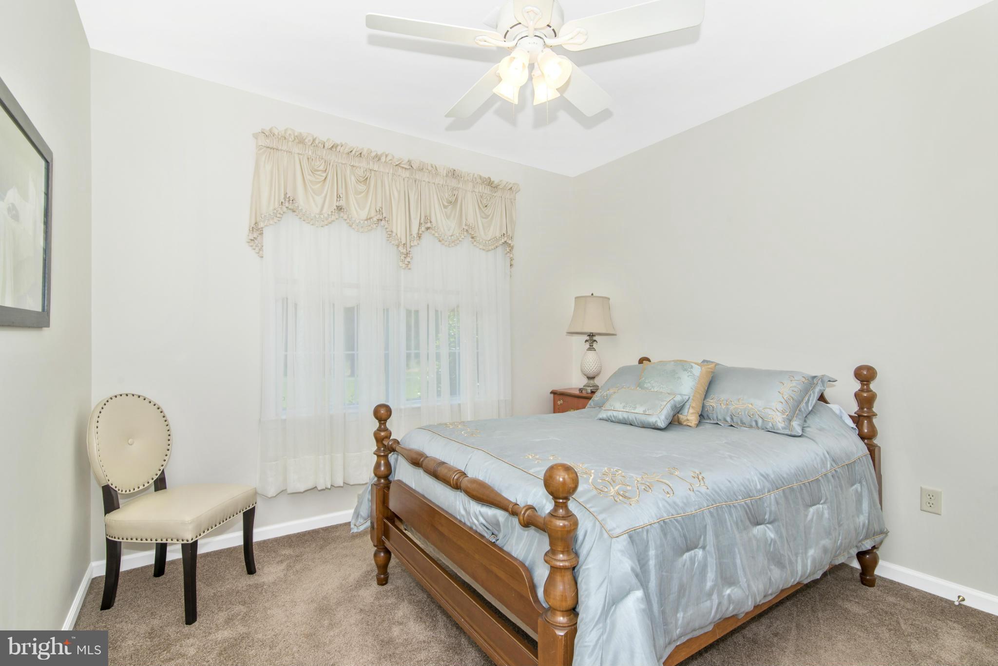 13928 Rockdale Road Clear Spring, MD 21722 - Photo 22 of 30 a bed sitting in a bedroom next to a window and a chandelier