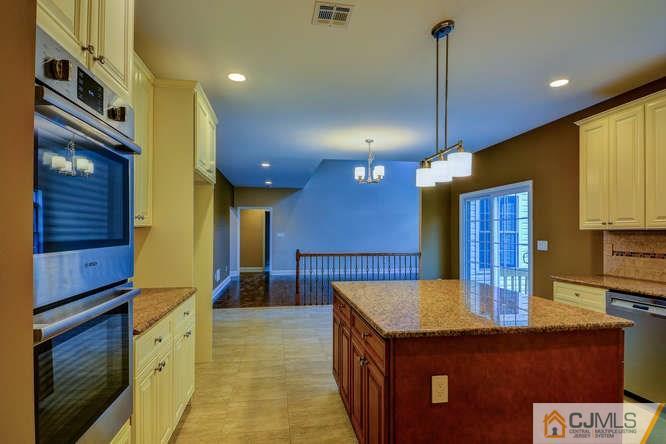 5 Homestead Road Edison, NJ 08820 - Photo 12 of 25 a kitchen that has a lot of cabinets in it