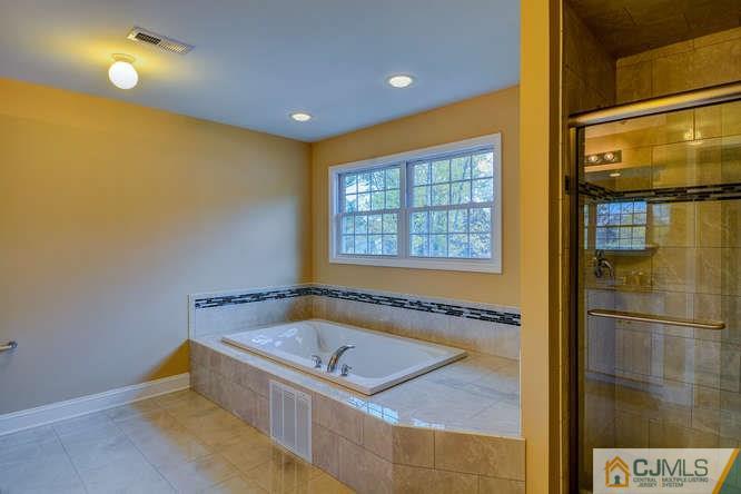 5 Homestead Road Edison, NJ 08820 - Photo 22 of 25 a bathroom with a tub and shower