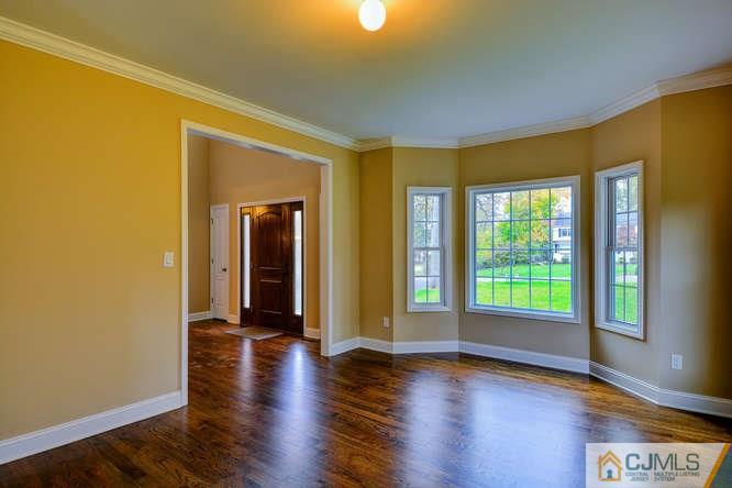 5 Homestead Road Edison, NJ 08820 - Photo 5 of 25 a view of an empty room with wooden floor and a window