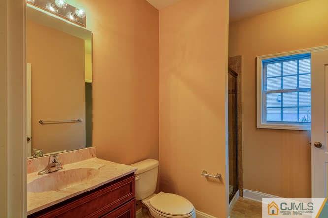 5 Homestead Road Edison, NJ 08820 - Photo 7 of 25 a bathroom with a sink a toilet and mirror