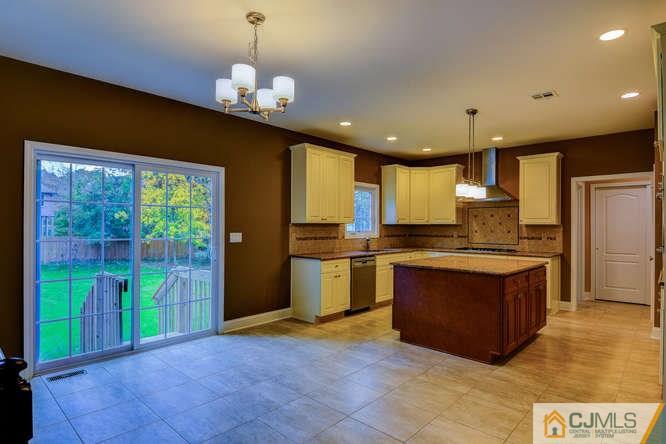 5 Homestead Road Edison, NJ 08820 - Photo 9 of 25 a kitchen with stainless steel appliances granite countertop a stove a sink and a refrigerator
