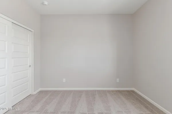 an empty room with closet area