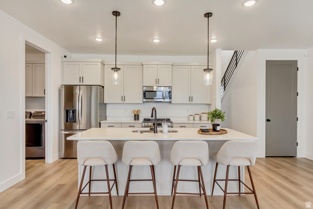 1389 1440 East, Unit 1 Payson, UT 84651 - Photo 4 of 17 Modern kitchen with an island featuring a white countertop and pendant lighting