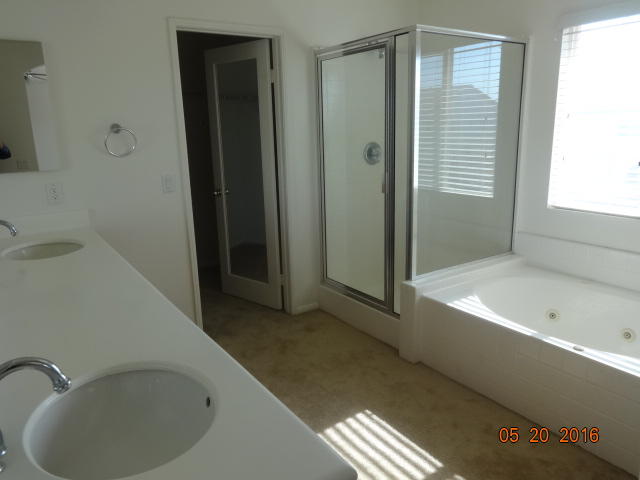 43660 Windrose Place Lancaster, CA 93536 - Photo 8 of 8 a bathroom with a bathtub and a shower