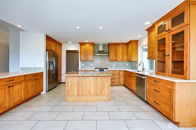 a large kitchen with stainless steel appliances granite countertop a large counter top and a stove