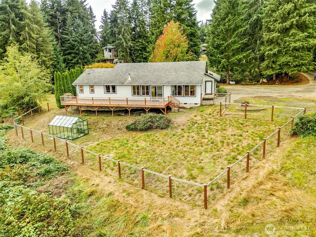 a aerial view of a house with swimming pool and sitting area