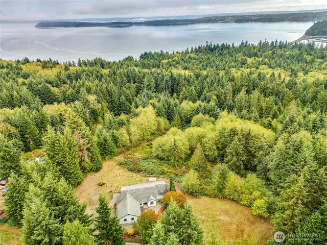 a view of a yard with wooden fence