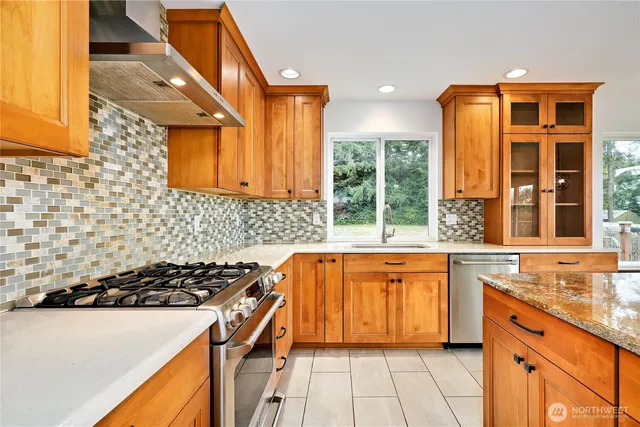a kitchen with a sink a stove and a refrigerator