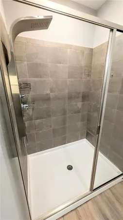 a white toilet sitting next to a shower