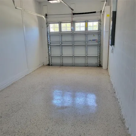 a view of a house with pool and chairs