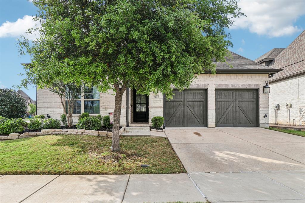 8277 Halifax The Colony, TX 75056 - Photo 1 of 37 a front view of a house with a yard and garage