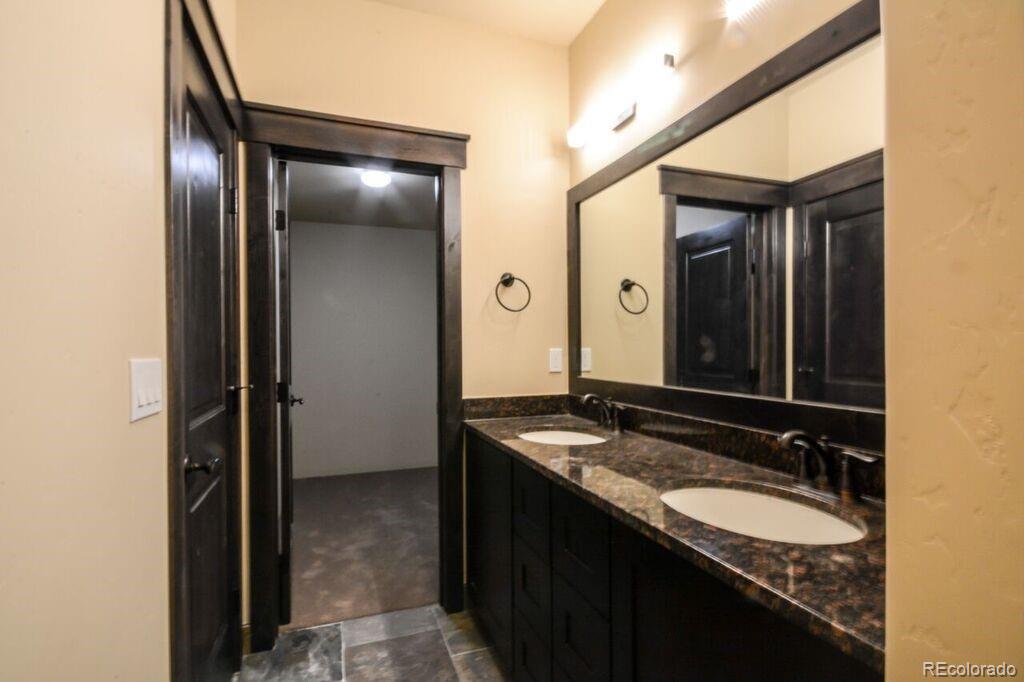 740 Independence Road, Unit 3C Keystone, CO 80435 - Photo 11 of 25 a bathroom with a granite countertop sink and a mirror