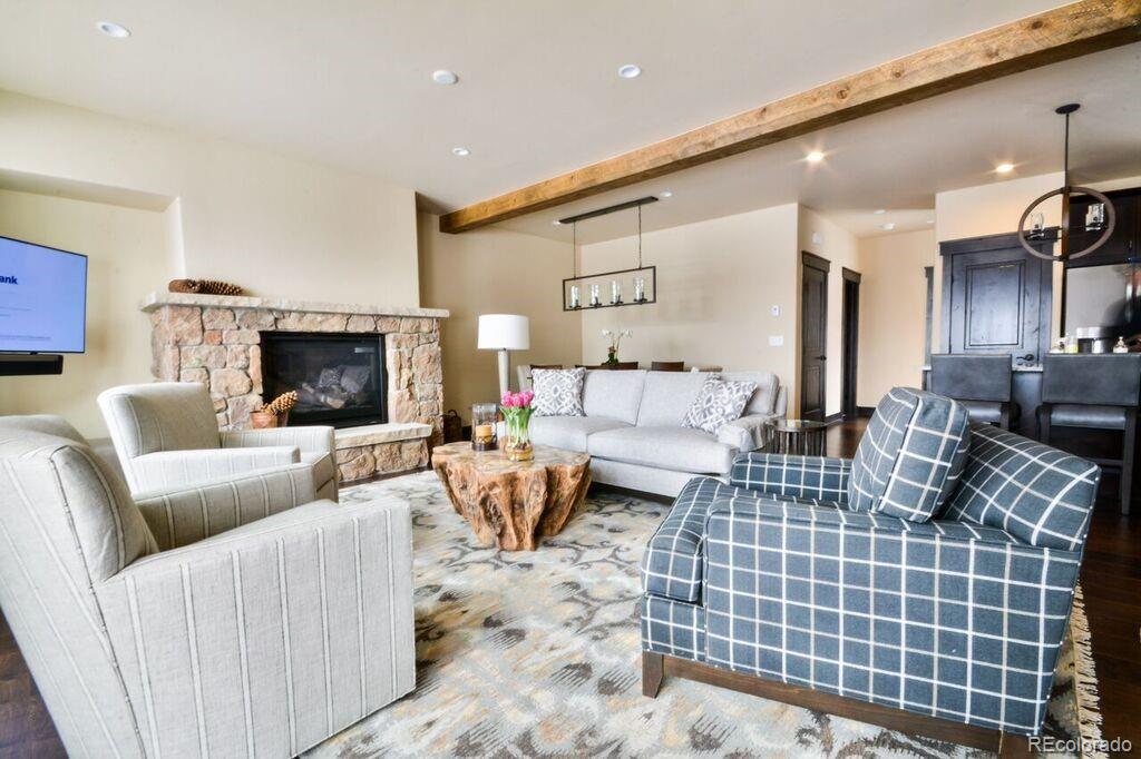 740 Independence Road, Unit 3C Keystone, CO 80435 - Photo 4 of 25 a living room with furniture a fireplace and a flat screen tv