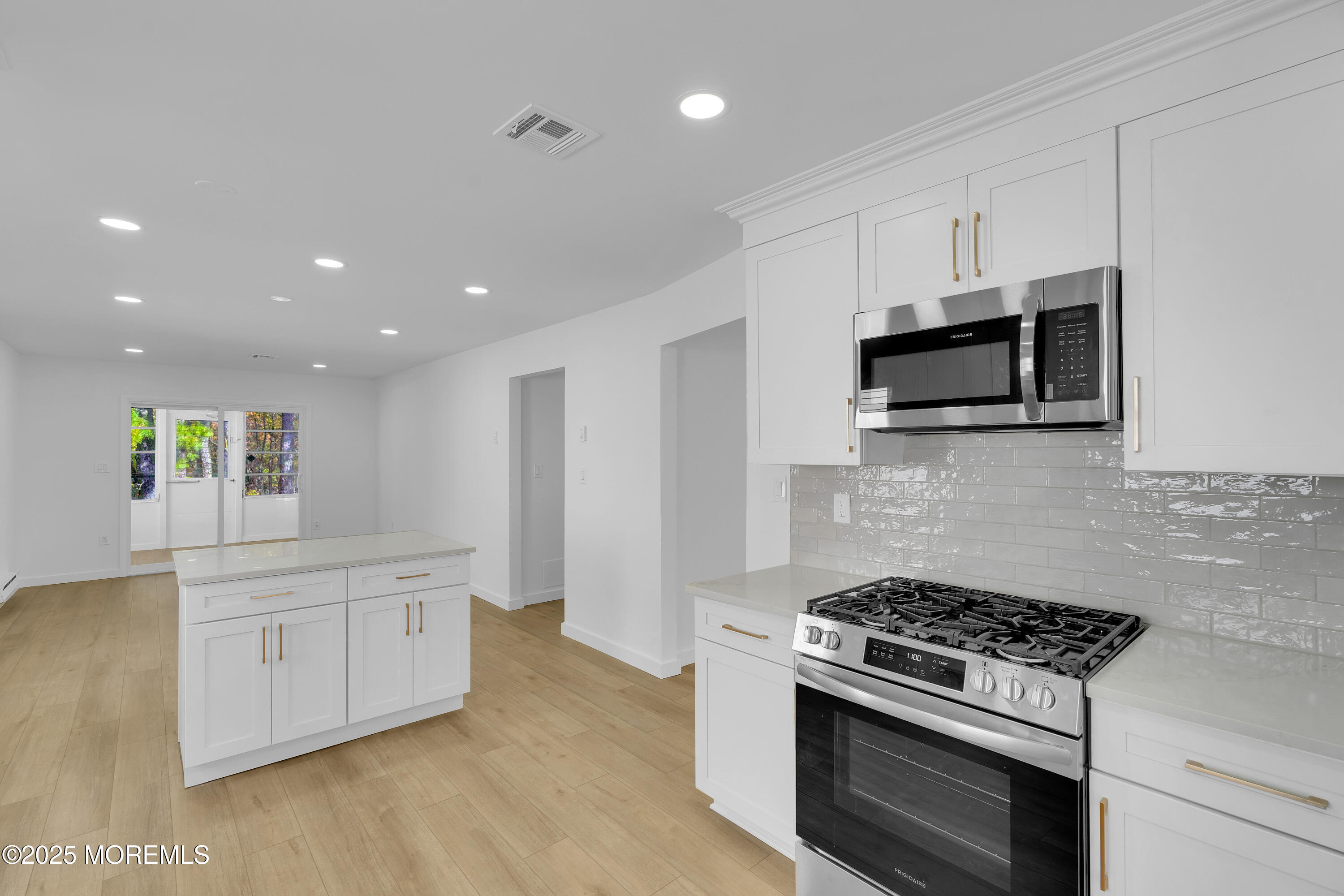 3 Tudor Court Brick, NJ 08723 - Photo 11 of 36 a kitchen with stainless steel appliances kitchen island granite countertop a stove a sink and a microwave