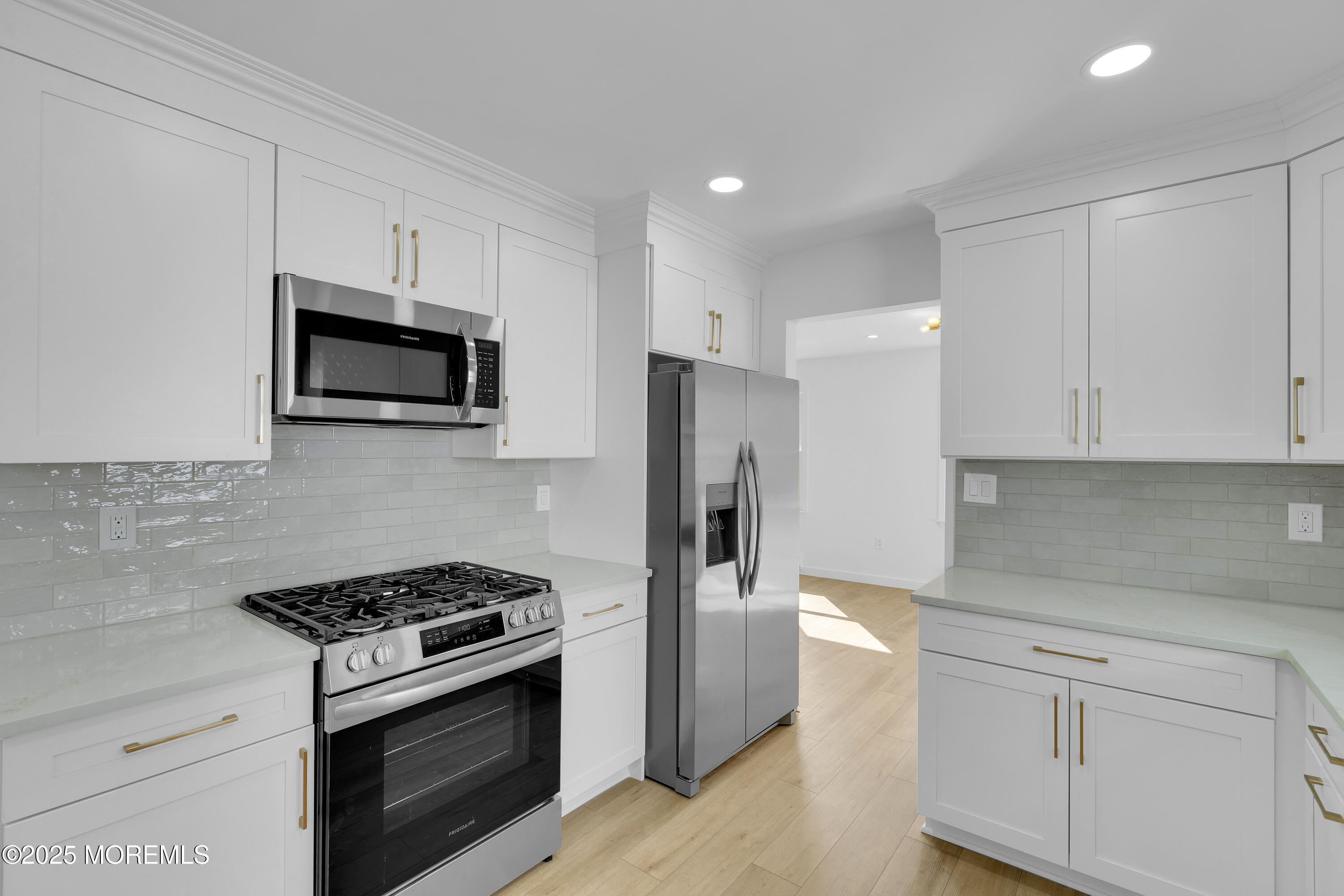 3 Tudor Court Brick, NJ 08723 - Photo 13 of 36 a kitchen with stainless steel appliances white cabinets and stove top oven