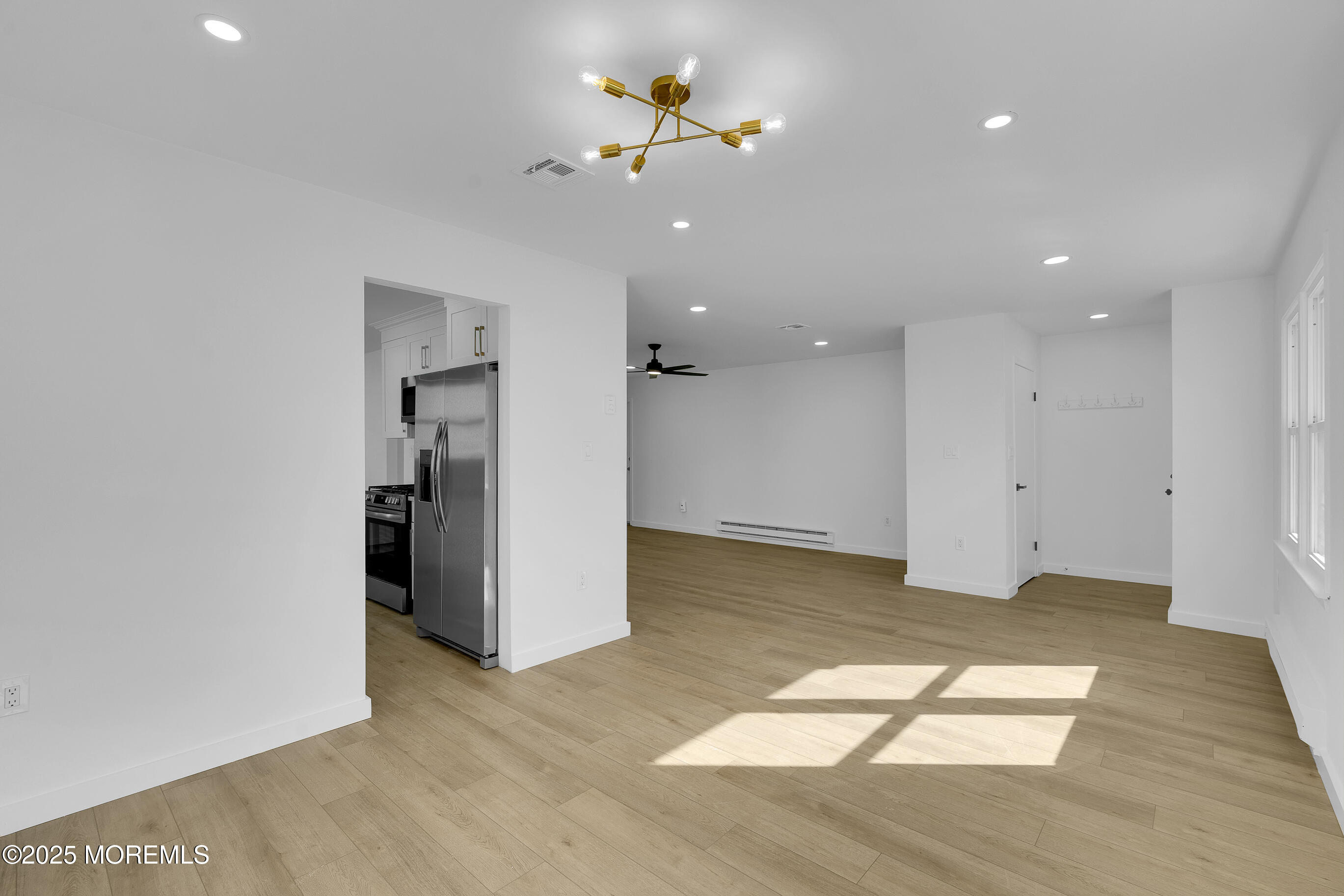 3 Tudor Court Brick, NJ 08723 - Photo 4 of 36 wooden floor in an empty room with a window