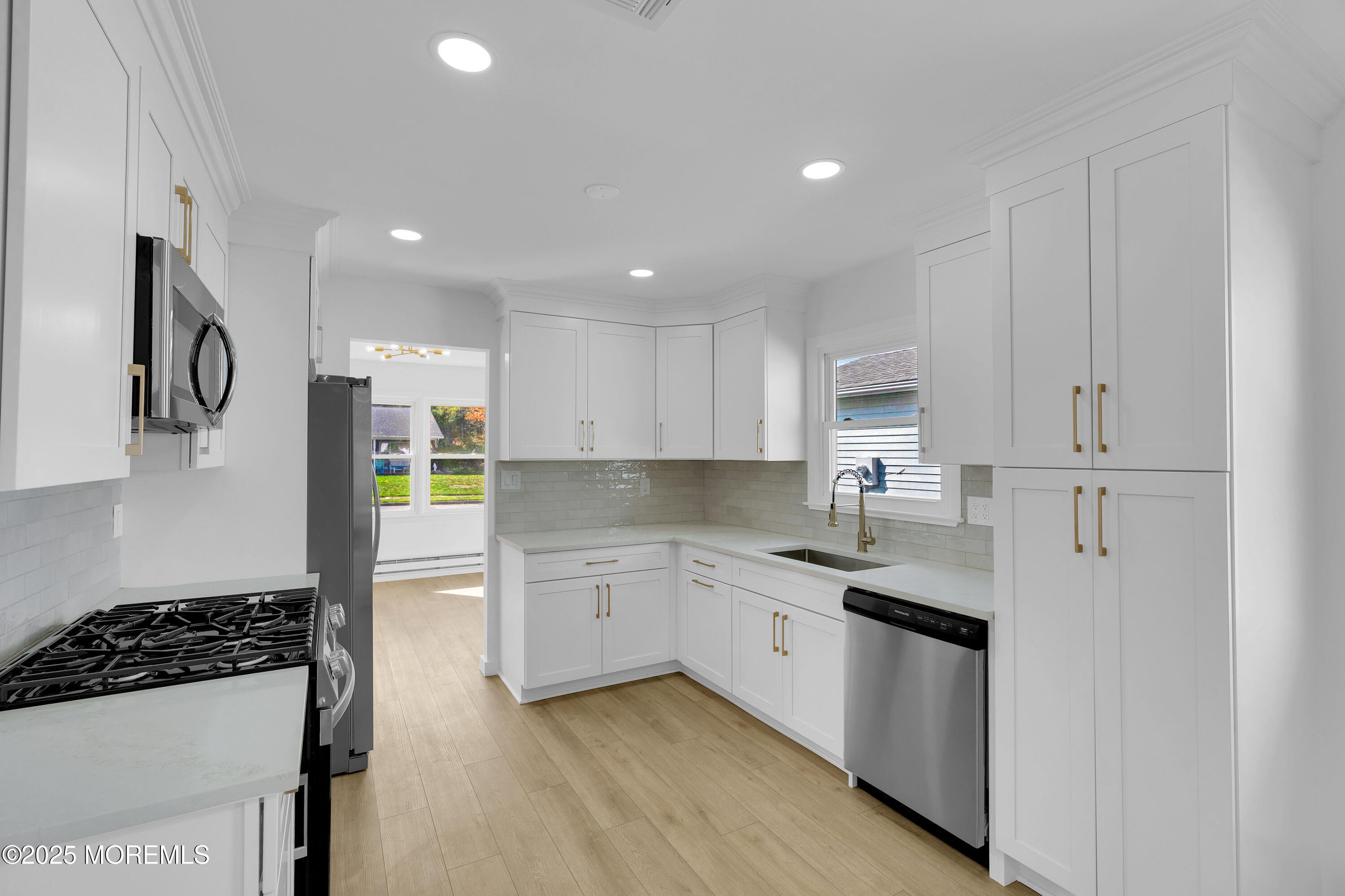 3 Tudor Court Brick, NJ 08723 - Photo 9 of 36 a kitchen with stainless steel appliances granite countertop a stove a sink and a refrigerator